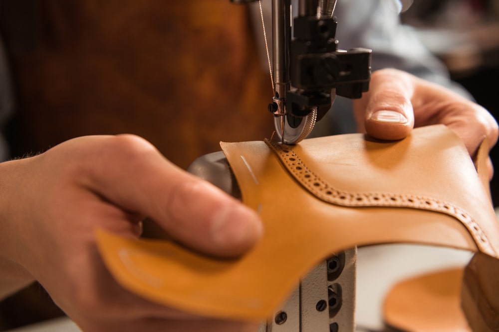 close-up-cobbler-stitching-part-shoe-min